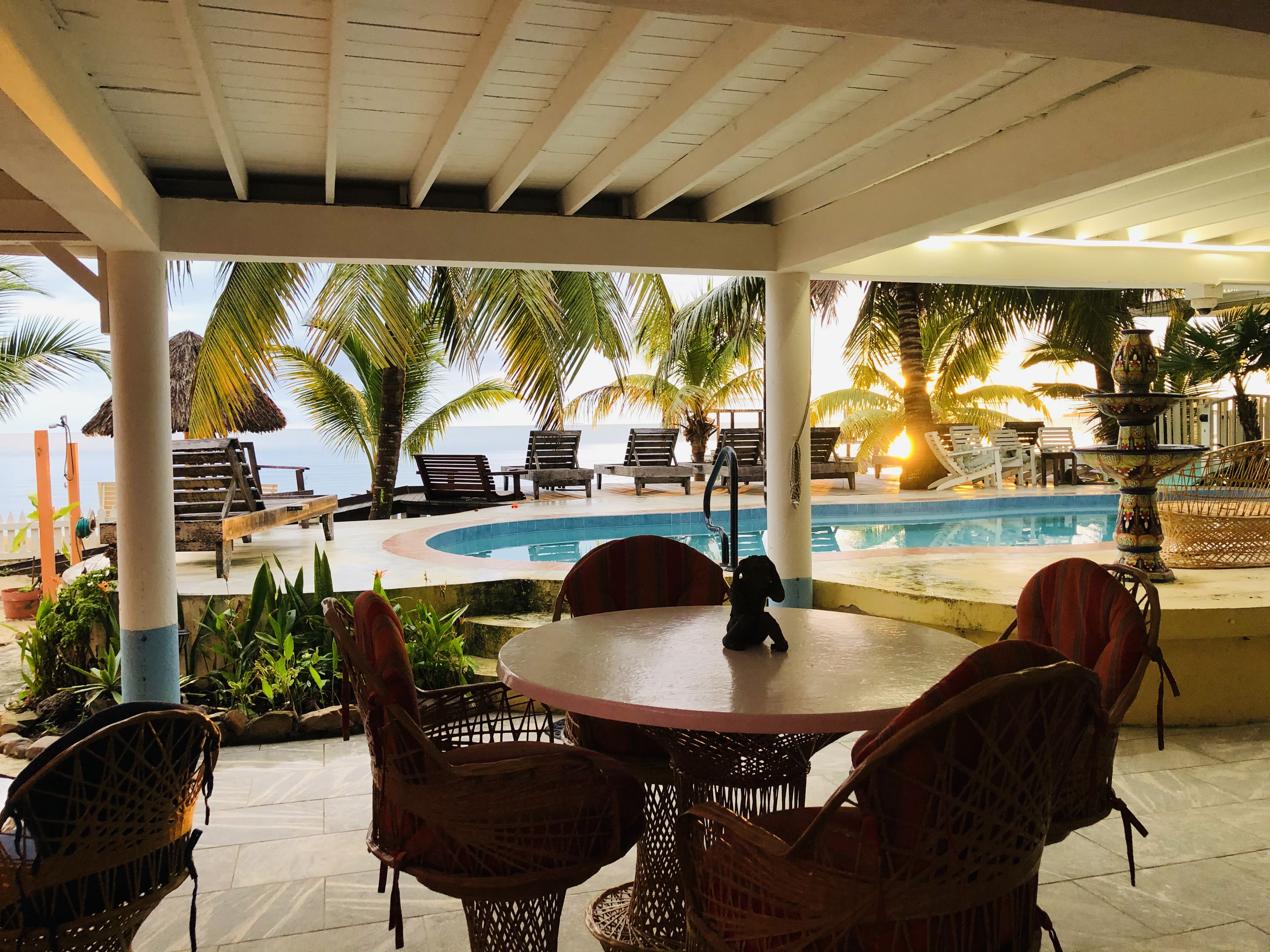 Open-air guest area looking across the pool to the Caribbean