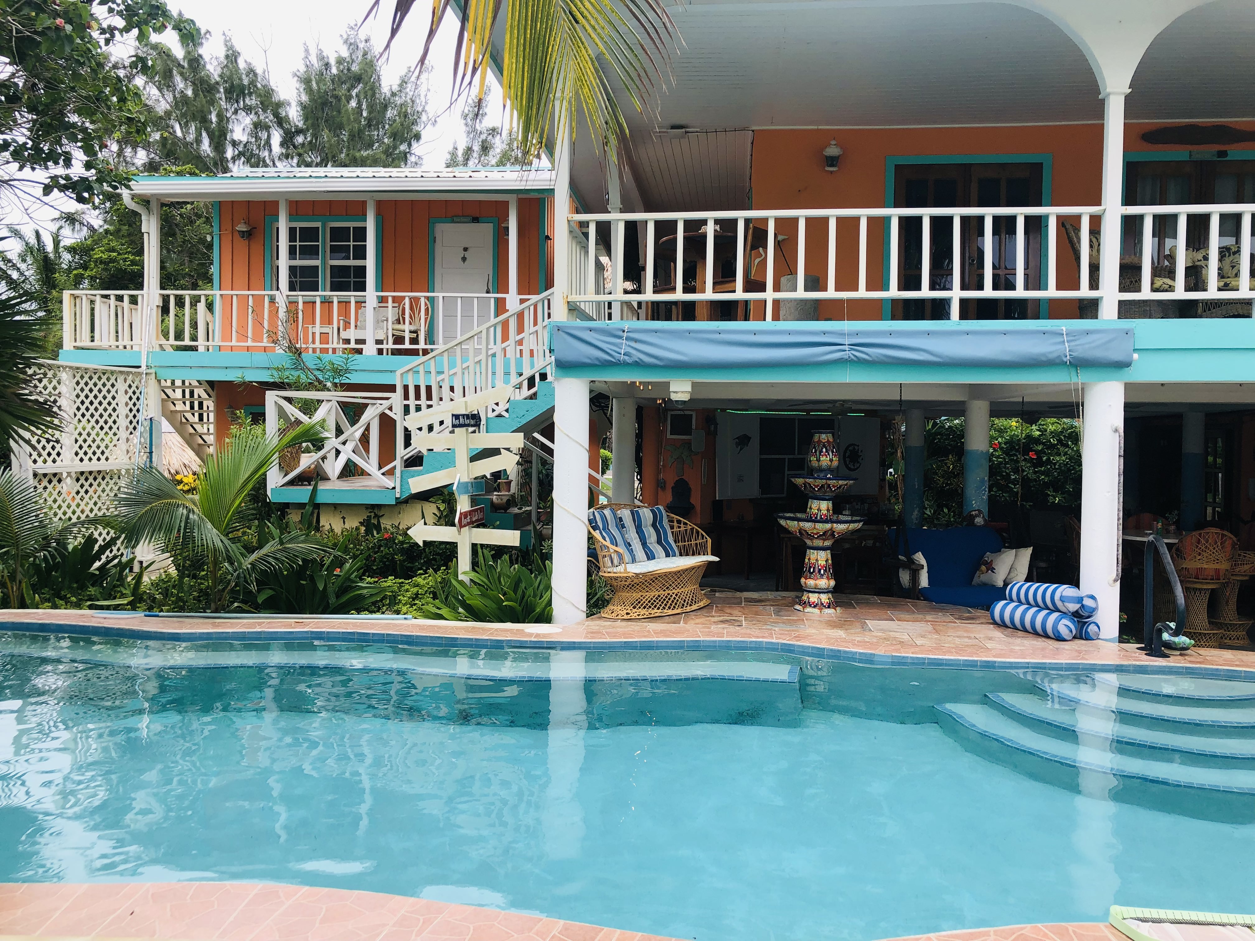 Colorful Coral Cove Inn buildings beside the pool